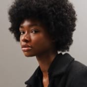 Portrait of Jessica Randall, a black woman with short curly black hair, wearing a black shirt